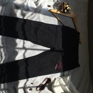 Black pants with a bee embroidered on the right